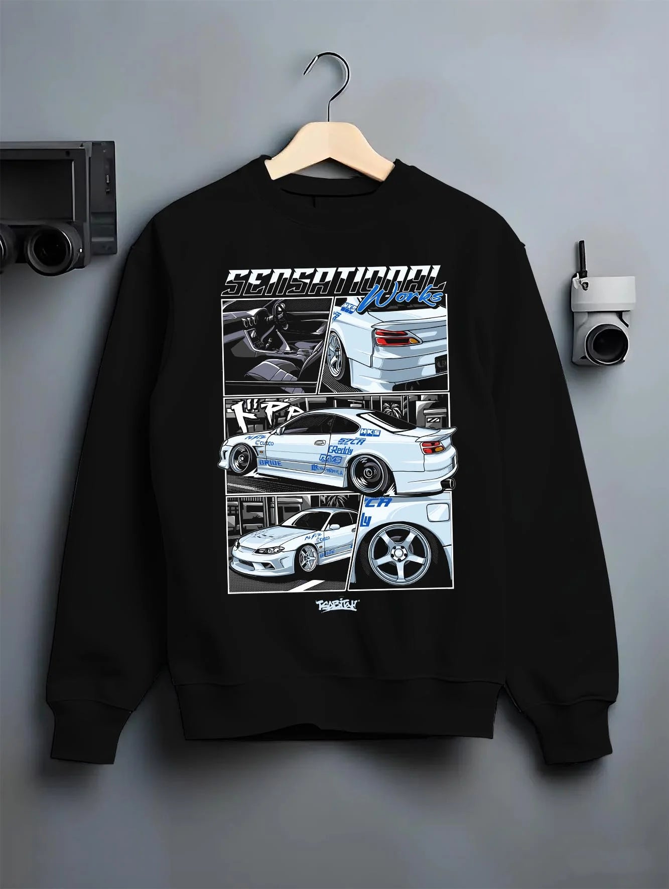 Black crewneck sweatshirt on a hanger against a grey wall, featuring Nissan Silvia S15 silvia turbo drift jdm street legend graphic.