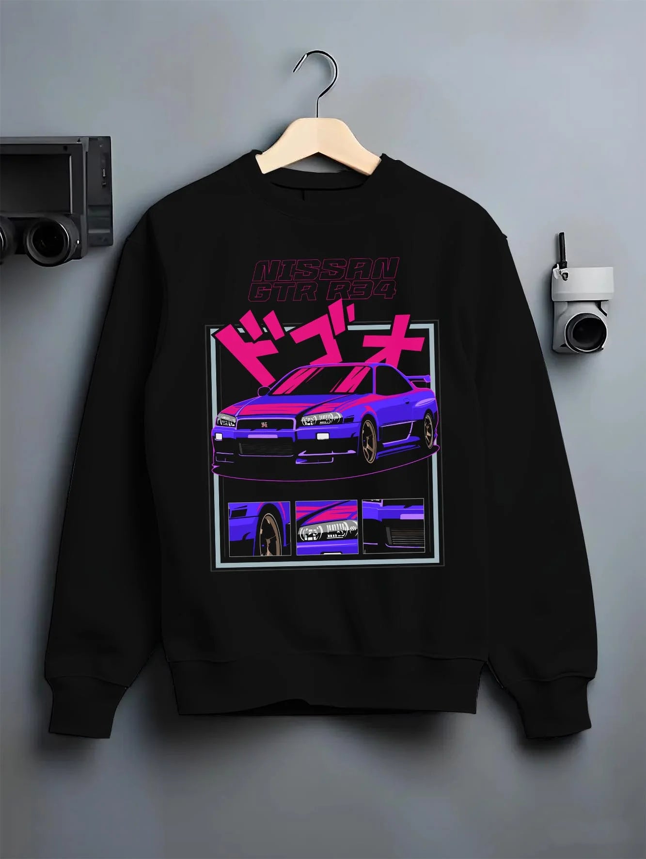 Black crewneck sweatshirt on a hanger against a grey wall, featuring Nissan Skyline turbo racing drift jdm japanese tuner graphic.