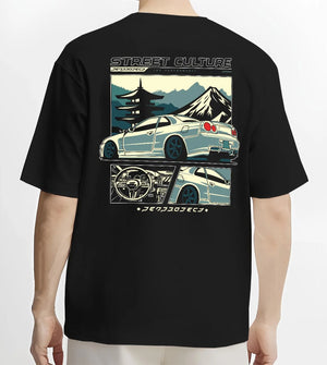 Black T-shirt worn by a male model, back view, featuring Nissan Skyline drift jdm japanese tuner street retro graphic.