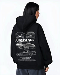 Black hoodie worn by a female model, back view, featuring Nissan Skyline R34 gtr r34 skyline drift jdm japanese tuner graphic.
