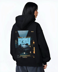 Black hoodie worn by a female model, back view, featuring Nissan Skyline R34 r34 skyline turbo racing drift jdm japanese graphic.