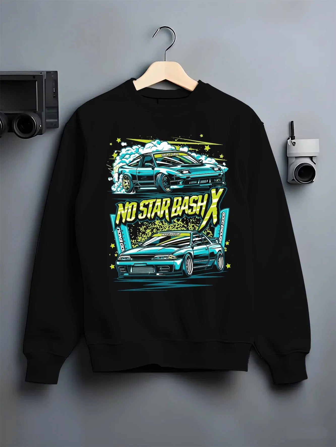 Black crewneck sweatshirt on a hanger against a grey wall, featuring STI street racing performance motorsport automotive graphic.