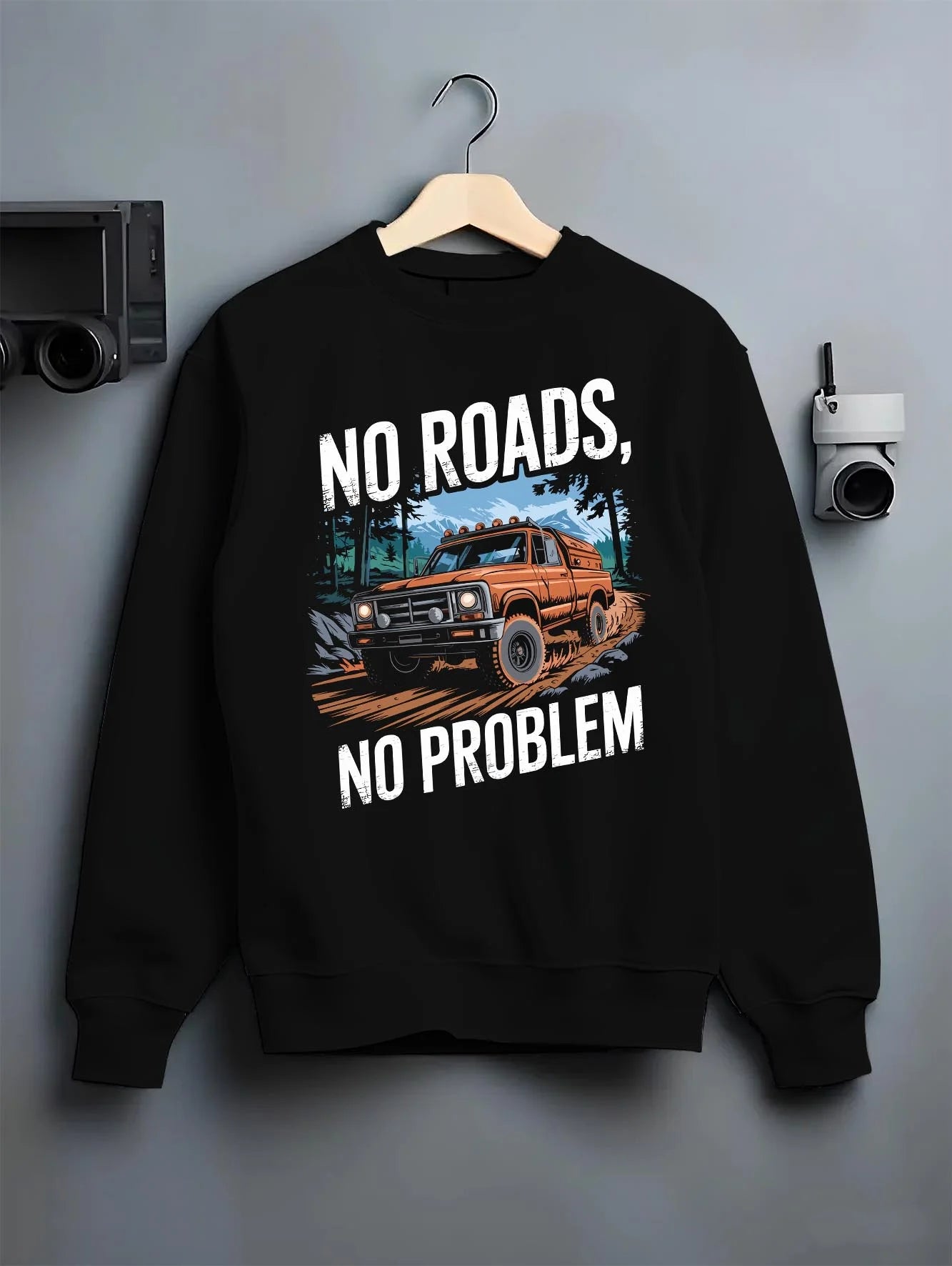 Black crewneck sweatshirt on a hanger against a grey wall, featuring street racing performance motorsport automotive nrnp.