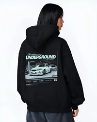 Black hoodie worn by a female model, back view, featuring Nissan 240SX rs turbo racing drift jdm japanese street classic graphic.