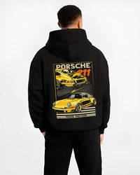 Black hoodie worn by a male model, back view, featuring Porsche 911 rs racing motorsport street retro vintage classic graphic.