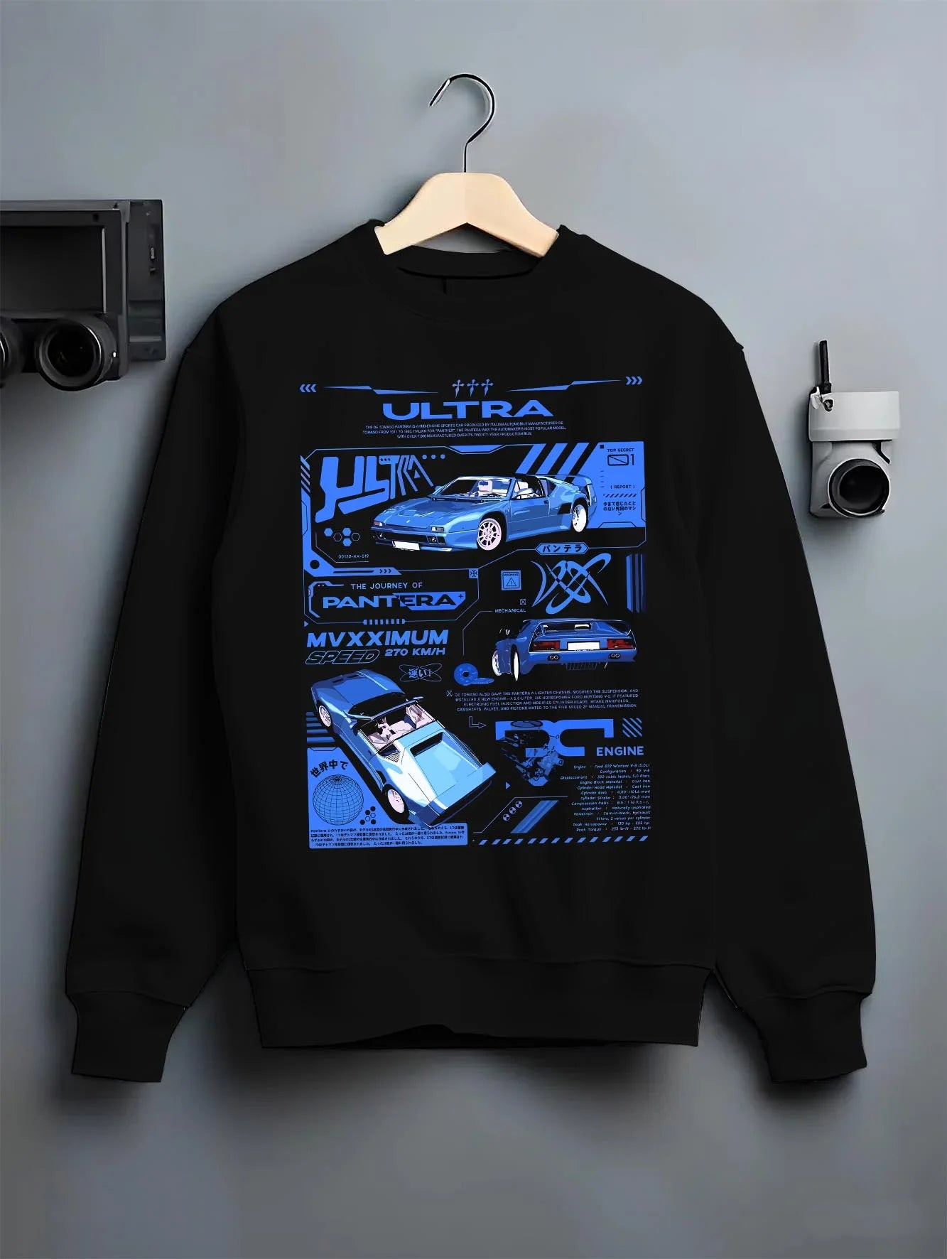 Black crewneck sweatshirt on a hanger against a grey wall, featuring racing italian street retro classic performance graphic.