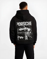 Black hoodie worn by a male model, back view, featuring Porsche Cayman rs turbo turbocharged racing german tuner street graphic.
