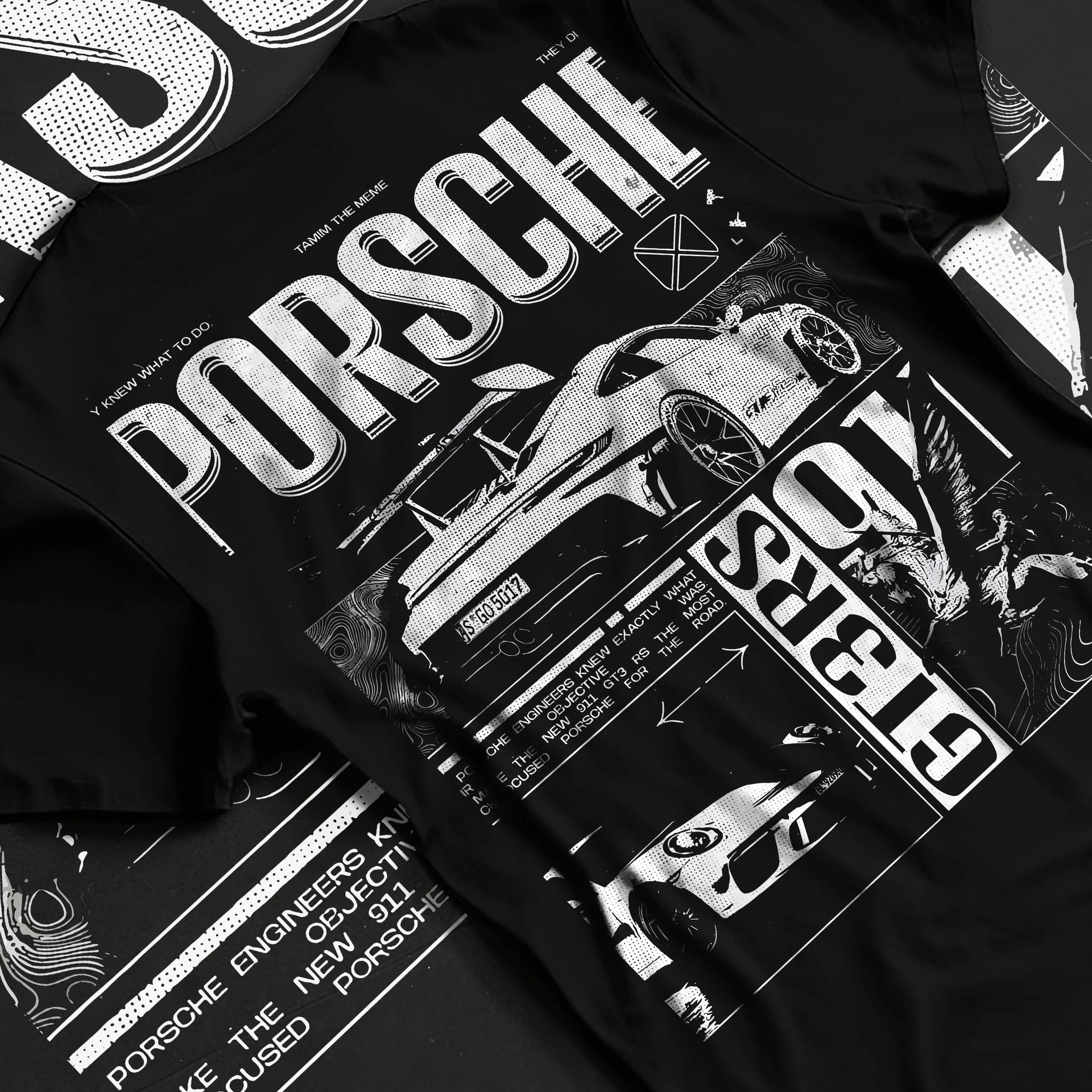 Black T-shirt laid flat with natural fabric folds, featuring Porsche Cayman rs turbo turbocharged racing german tuner graphic.