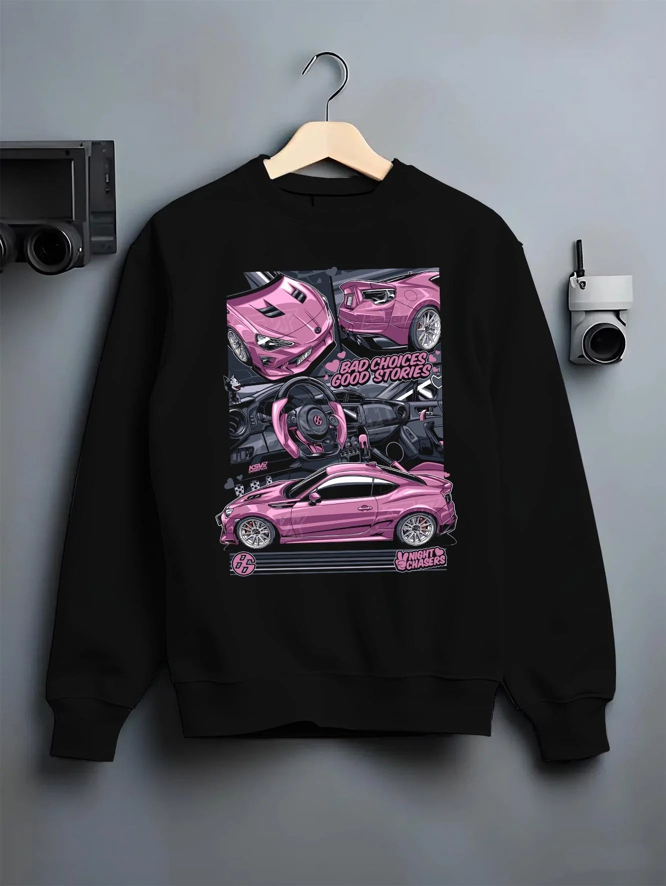 Black crewneck sweatshirt on a hanger against a grey wall, featuring Toyota 86 drift jdm stance street racing performance graphic.