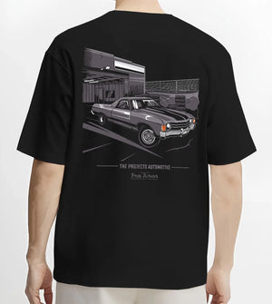 Black T-shirt worn by a male model, back view, featuring CHEVROLET muscle retro classic enthusiast racing street graphic.