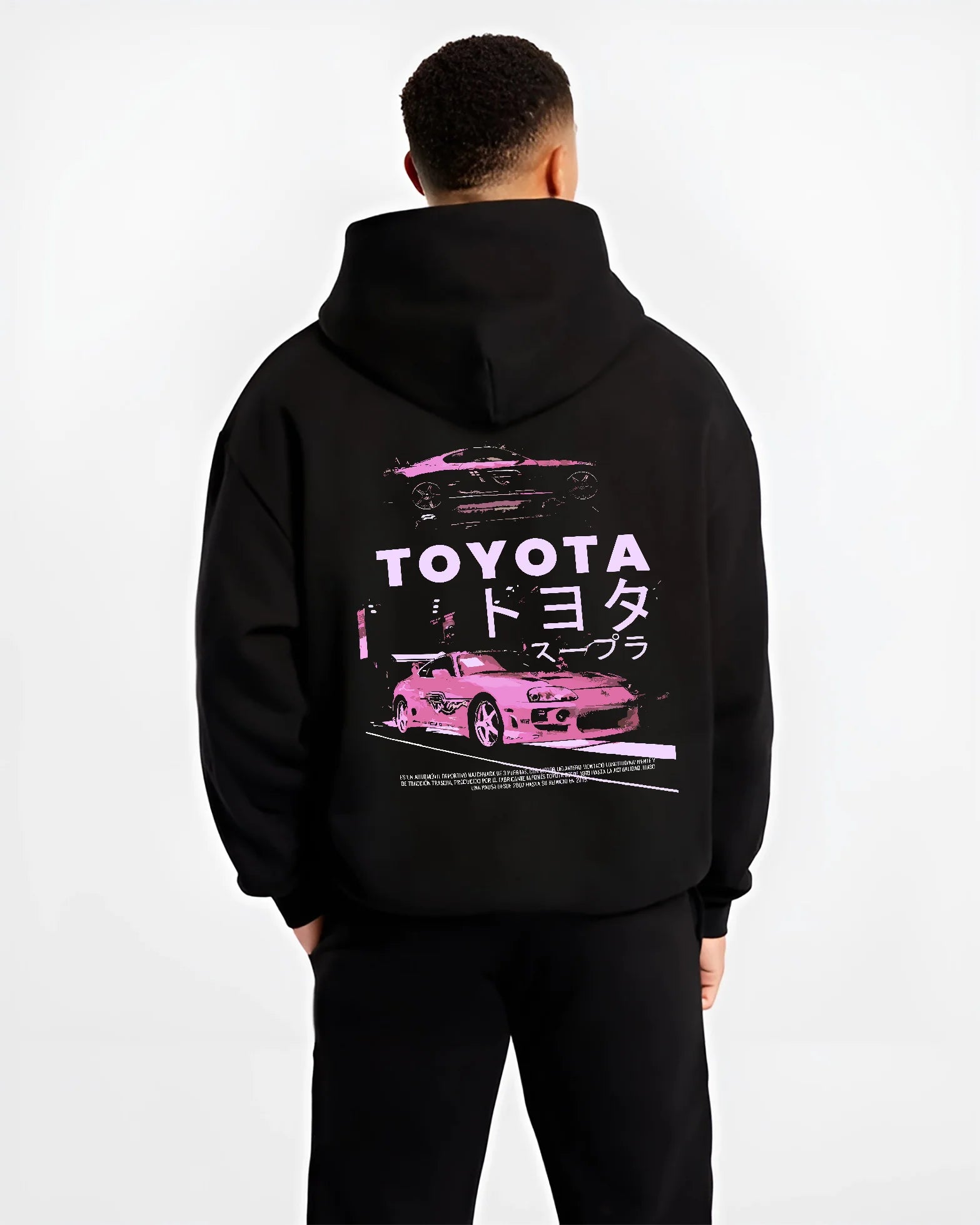 Black hoodie worn by a male model, back view, featuring Toyota Supra racing drift jdm japanese tuner street retro graphic.