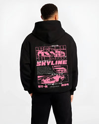 Black hoodie worn by a male model, back view, featuring Nissan SKYLINE r34 turbo racing drift jdm japanese street retro graphic.