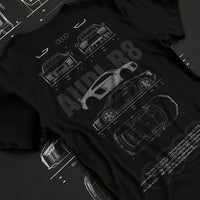 Black T-shirt laid flat with natural fabric folds, featuring Audi R8 v10 euro enthusiast racing street performance graphic.