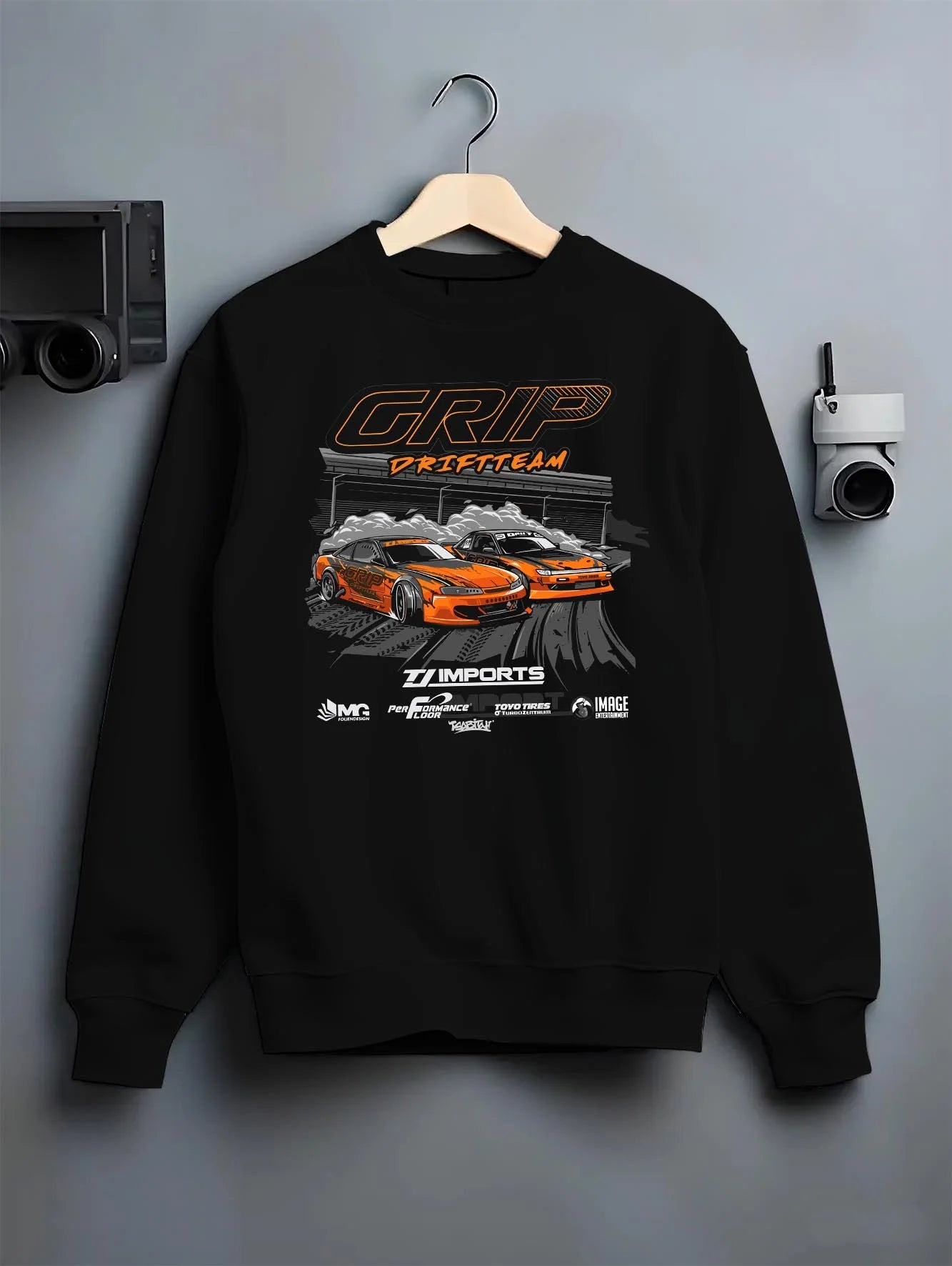 Black crewneck sweatshirt on a hanger against a grey wall, featuring rs racing drift motorsport jdm japanese stance street graphic.