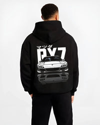 Black hoodie worn by a male model, back view, featuring Mazda RX-7 rx7 drift japanese tuner stance street graphic.