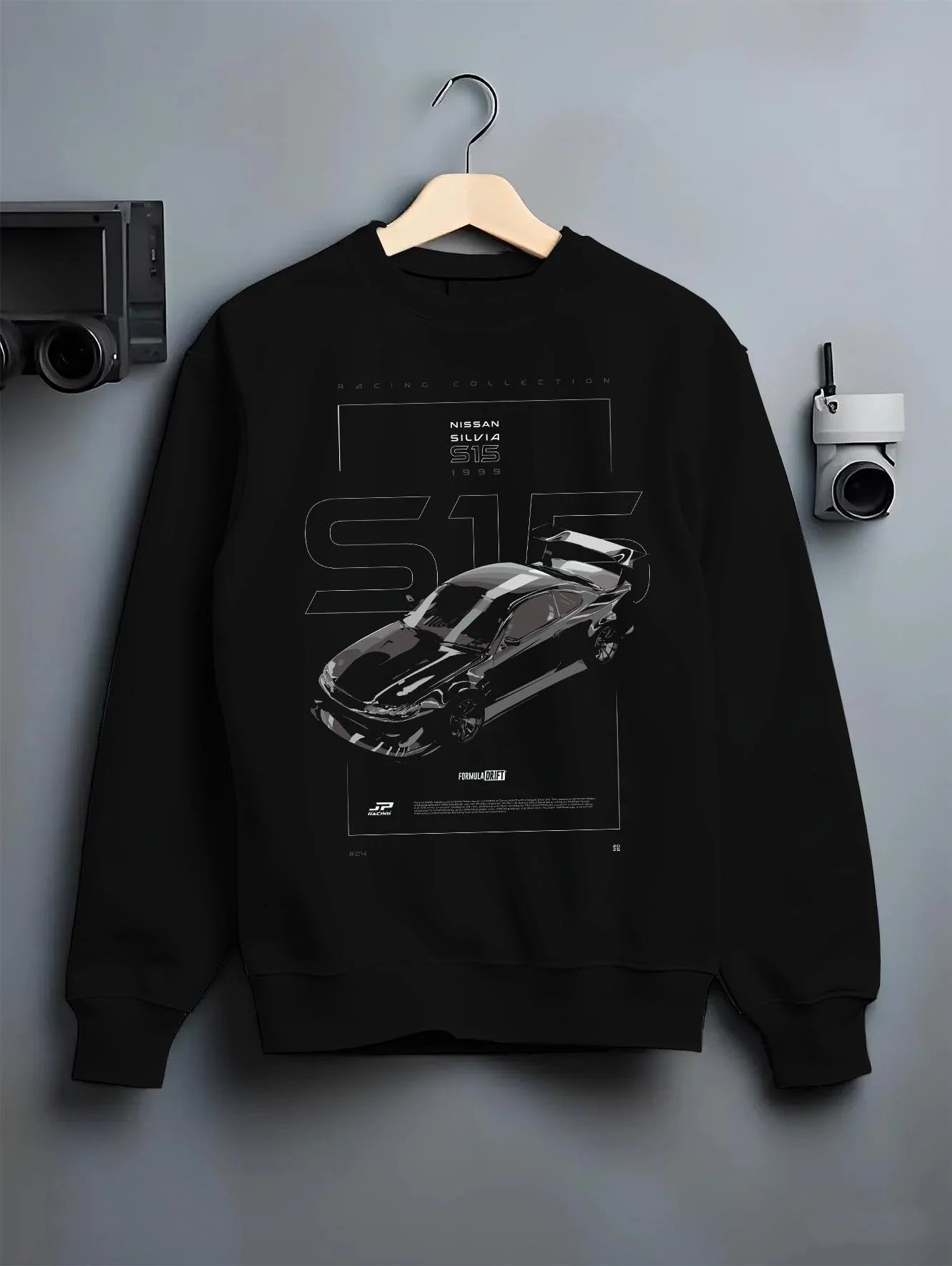 Black crewneck sweatshirt on a hanger against a grey wall, featuring Nissan Silvia S15 silvia turbo turbocharged racing s15drf.