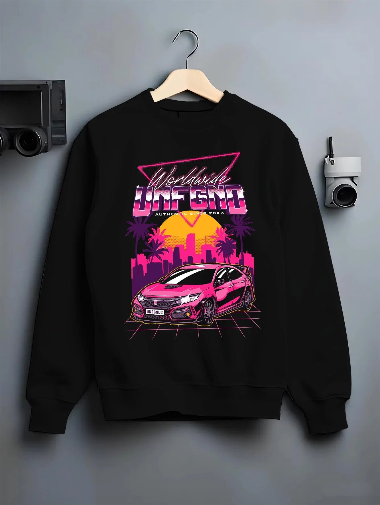 Black crewneck sweatshirt on a hanger against a grey wall, featuring Honda S2000 rs racing motorsport jdm tuner street graphic.