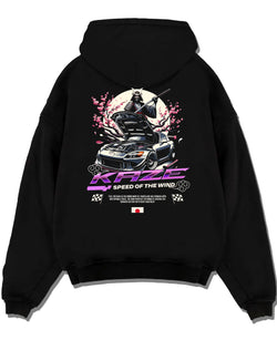 Black pullover hoodie laid flat on a white background, featuring drift japanese street retro racing performance motorsport graphic.