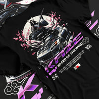 Black T-shirt laid flat with natural fabric folds, featuring drift japanese street retro racing performance motorsport graphic.