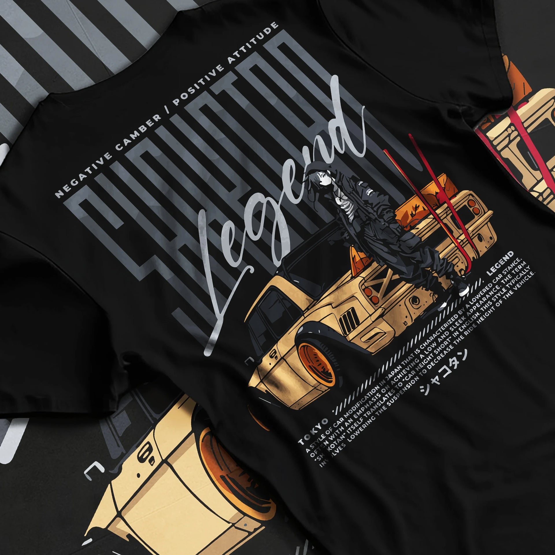 Black T-shirt laid flat with natural fabric folds, featuring Toyota jdm stance legend racing street performance motorsport graphic.