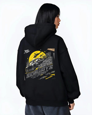 Black hoodie worn by a female model, back view, featuring rs turbo turbocharged racing drift jdm japanese tuner tokyo graphic.