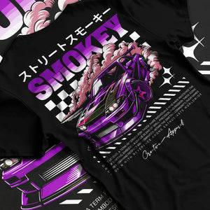 Black T-shirt laid flat with natural fabric folds, featuring racing drift muscle street retro classic performance graphic.