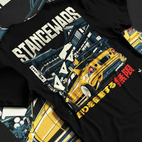 Black T-shirt laid flat with natural fabric folds, featuring drift jdm tuner stance slammed stanced racing street graphic.
