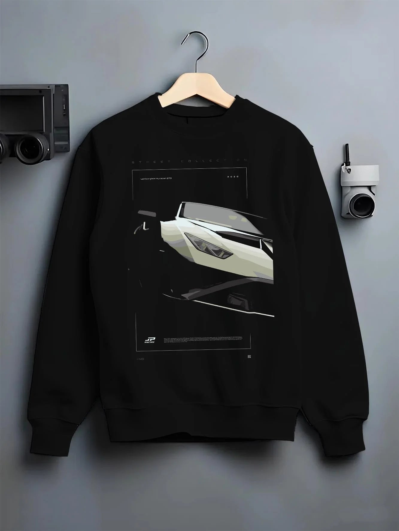 Black crewneck sweatshirt on a hanger against a grey wall, featuring rs turbo racing track street enthusiast performance graphic.