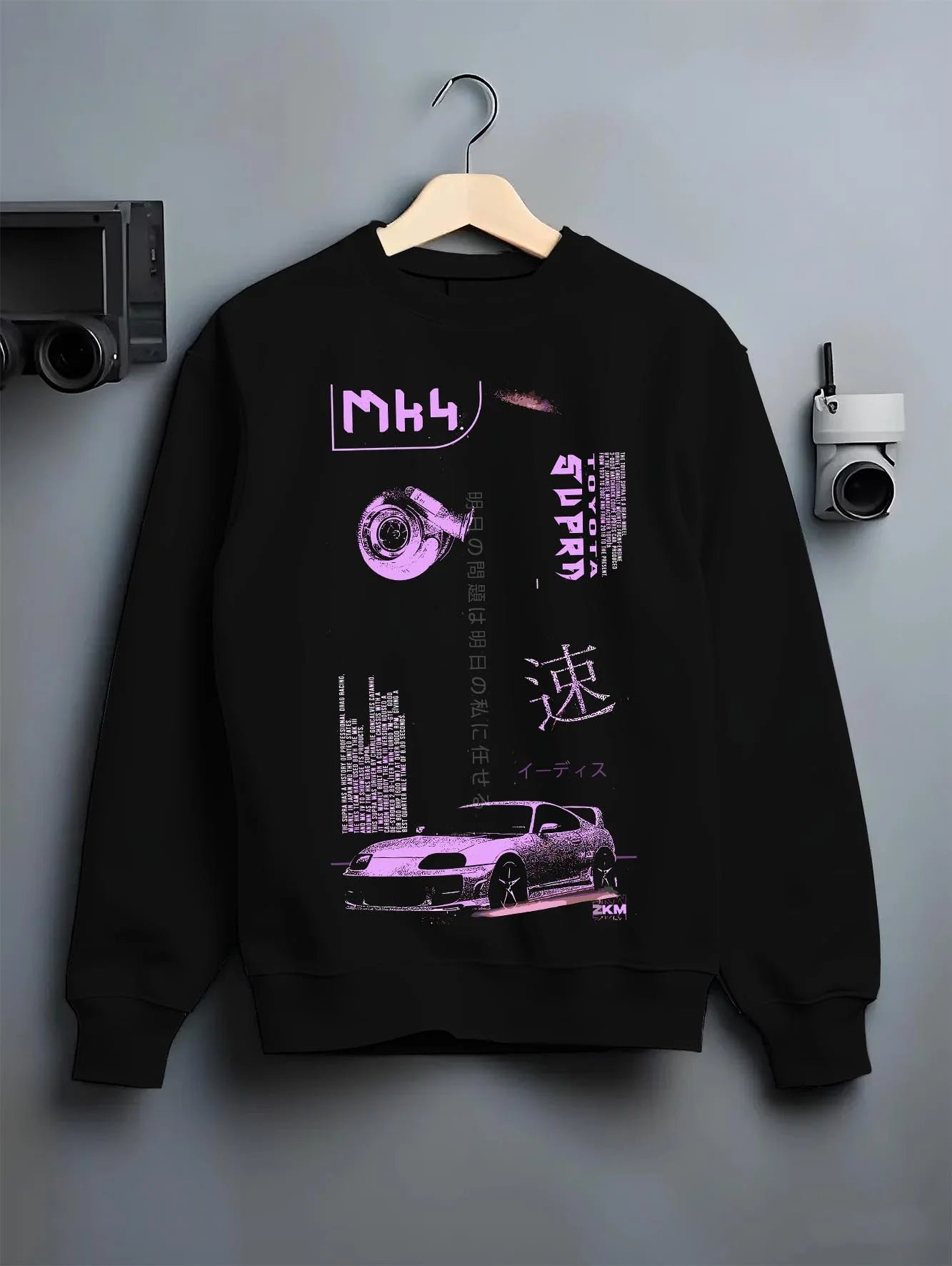 Black crewneck sweatshirt on a hanger against a grey wall, featuring Toyota Supra MK4 supra turbo racing drift jdm japanese graphic.