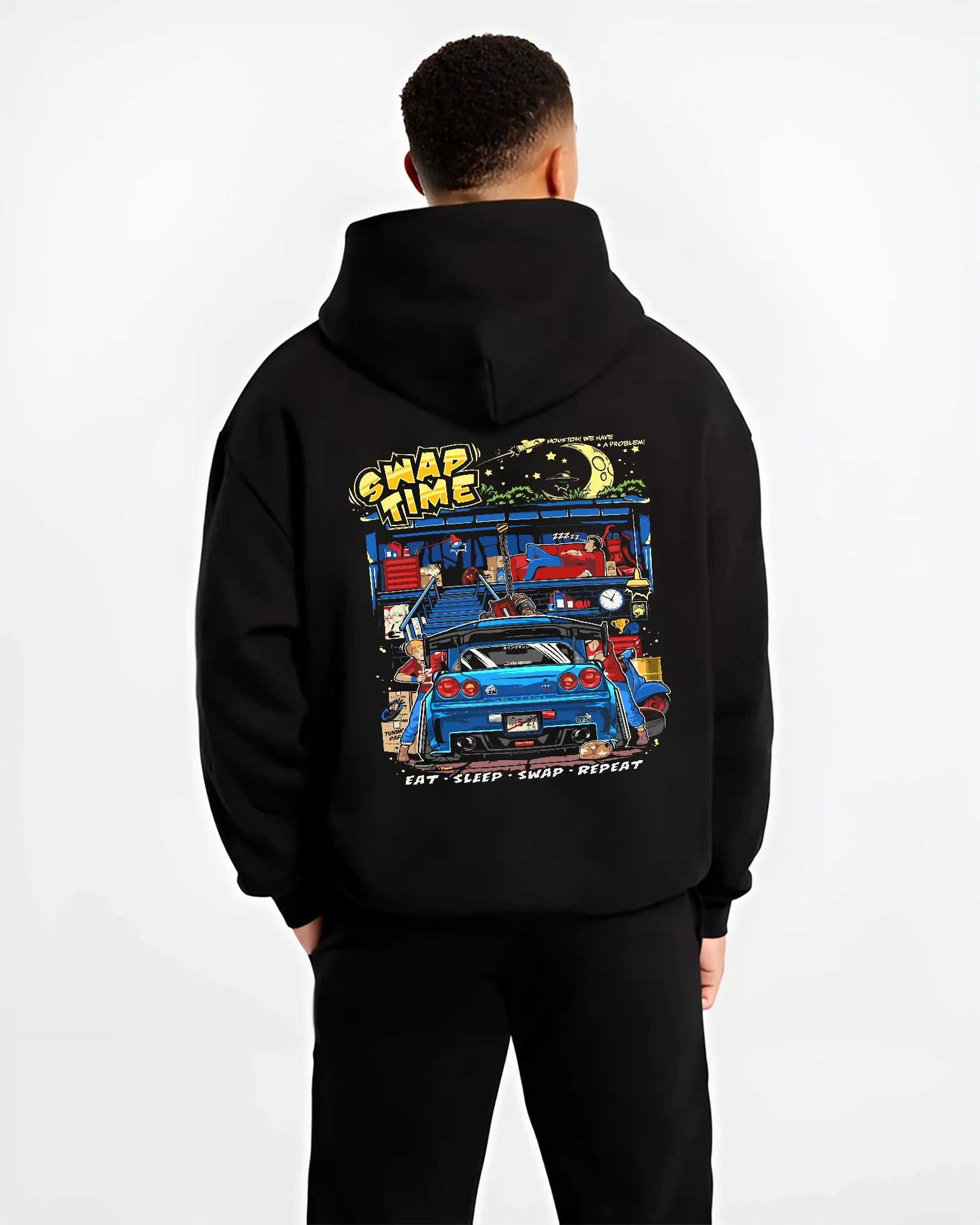 Black hoodie worn by a male model, back view, featuring Nissan Skyline R34 r34 skyline racing drift jdm tuner street graphic.