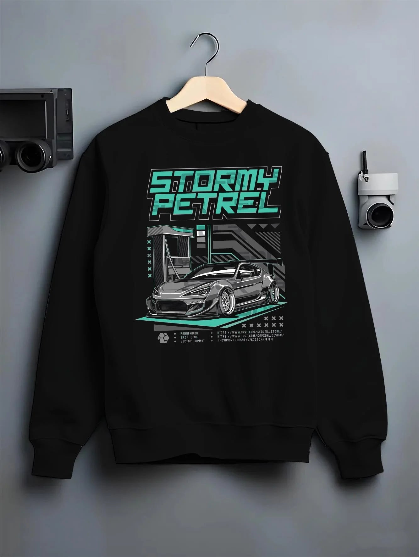 Black crewneck sweatshirt on a hanger against a grey wall, featuring Toyota racing drift jdm tuner stance widebody street graphic.