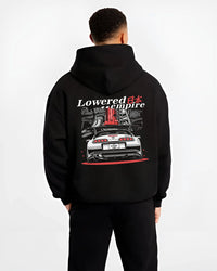 Black hoodie worn by a male model, back view, featuring Toyota Supra turbo drift jdm lowered power racing graphic.