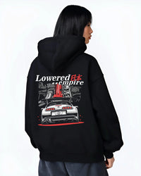 Black hoodie worn by a female model, back view, featuring Toyota Supra turbo drift jdm lowered power racing graphic.