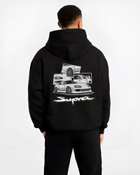 Black hoodie worn by a male model, back view, featuring Toyota Supra turbo turbocharged jdm street classic racing graphic.