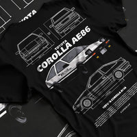 Black T-shirt laid flat with natural fabric folds, featuring Toyota AE86 drift legend racing street performance motorsport graphic.