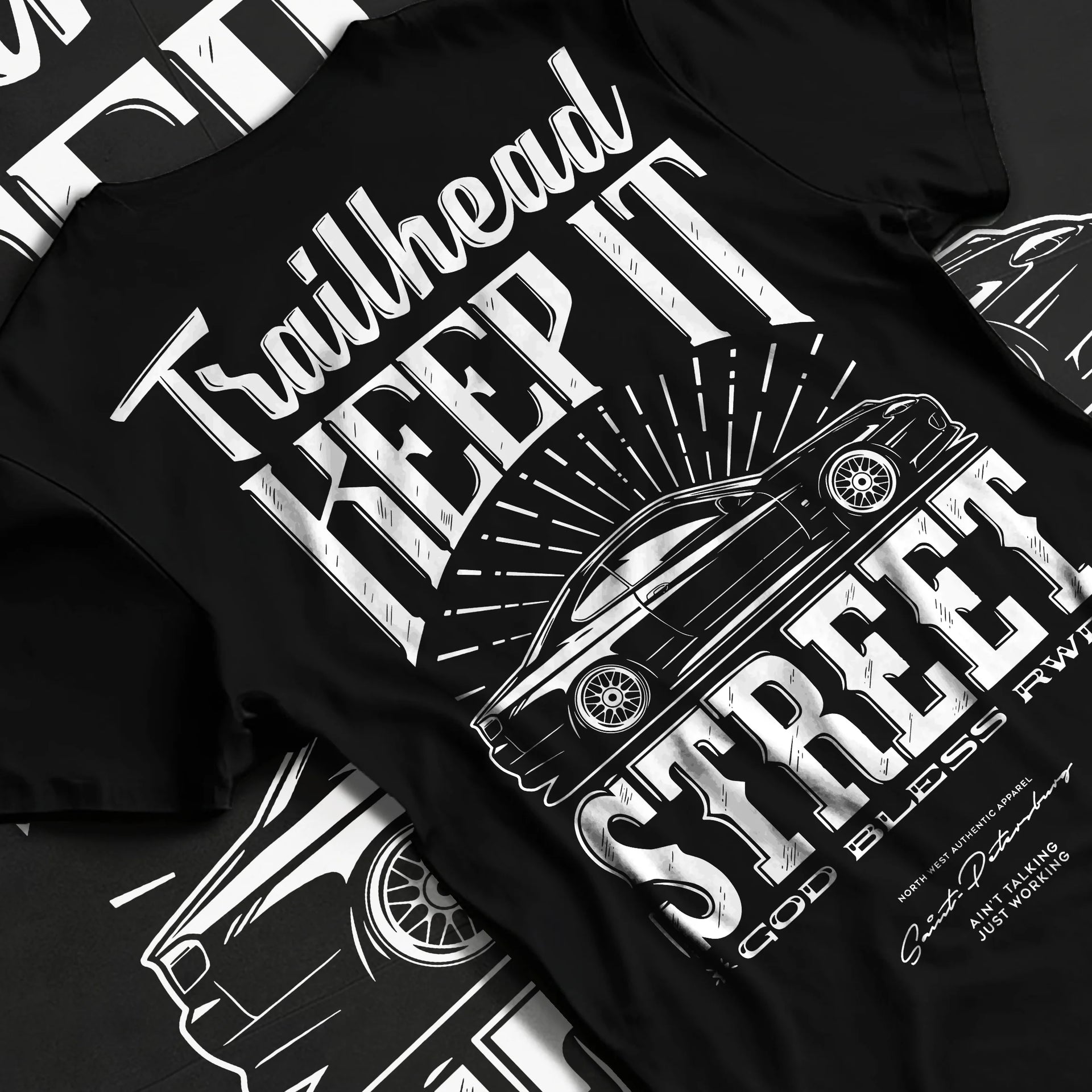 Black T-shirt laid flat with natural fabric folds, featuring rs racing race street enthusiast performance motorsport graphic.