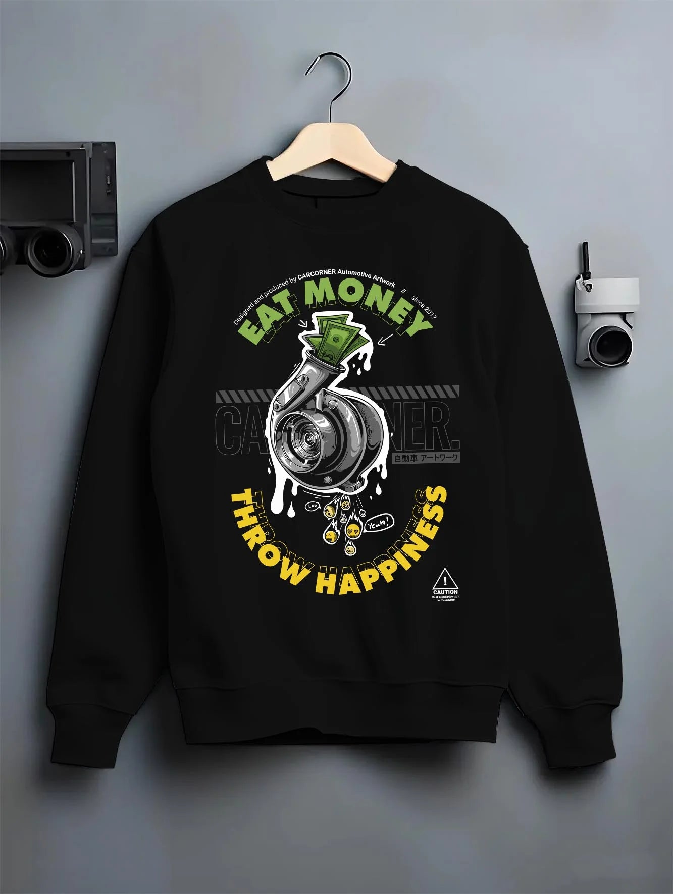 Black crewneck sweatshirt on a hanger against a grey wall, featuring turbo boost racing jdm tuning street performance graphic.