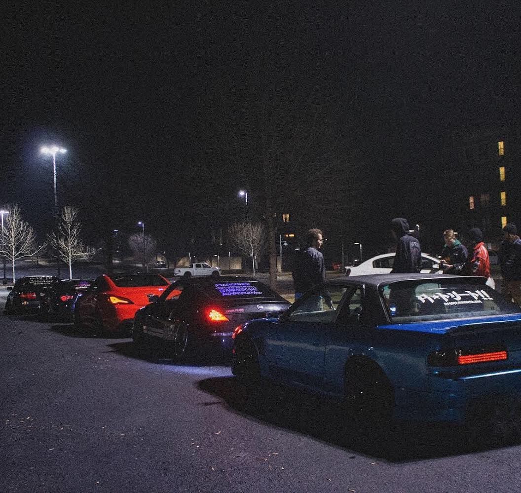 JDM car meet at night with modified Nissan S-chassis and imports, Trackhead Apparel car culture streetwear scene