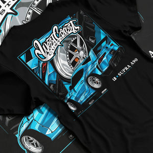Black T-shirt laid flat with natural fabric folds, featuring Toyota Supra racing jdm tuning street enthusiast performance graphic.
