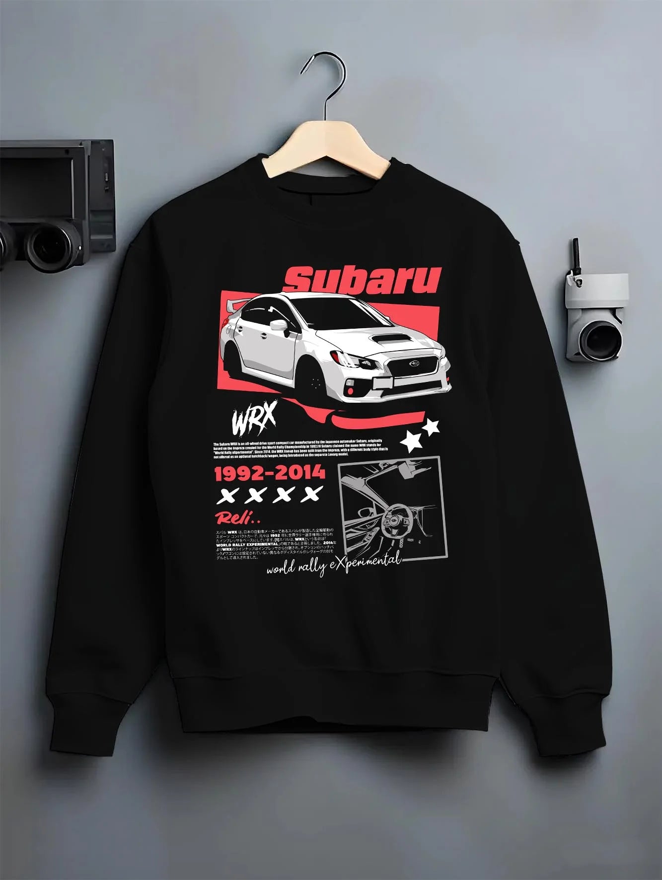 Black crewneck sweatshirt on a hanger against a grey wall, featuring Subaru WRX STI sti wrx turbo turbocharged racing rally graphic.